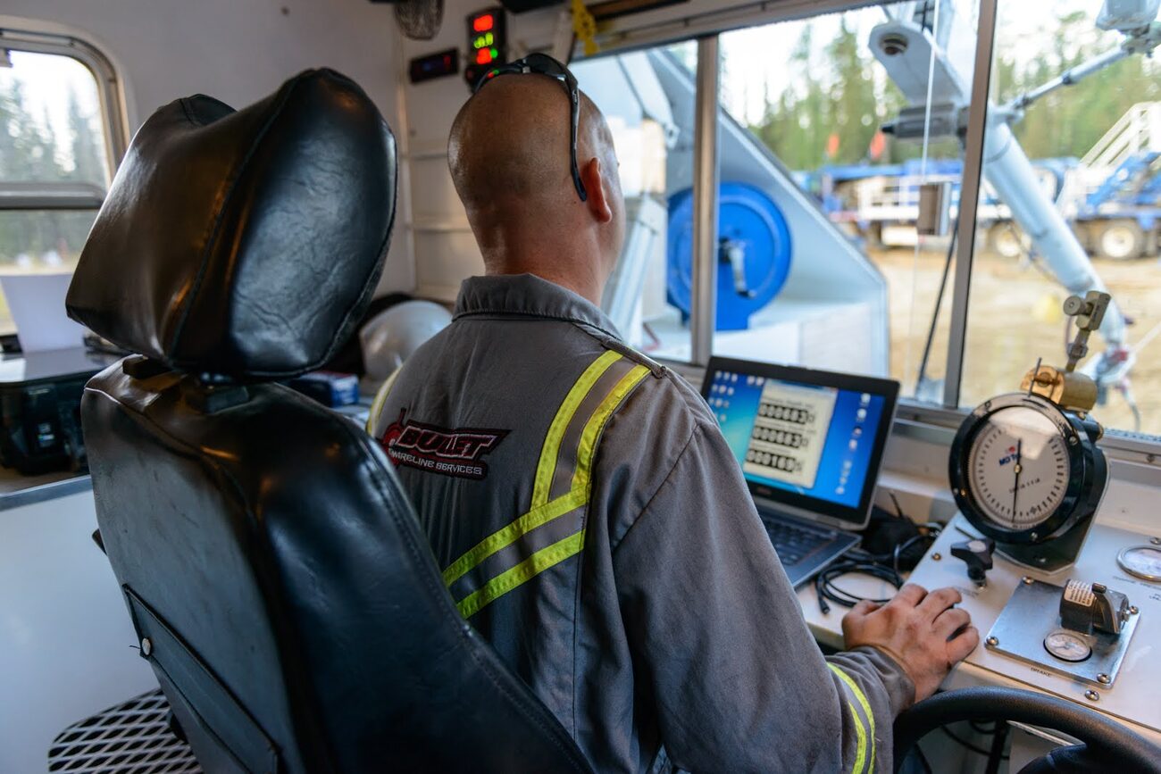 Slickline operator monitoring a job from the control cab