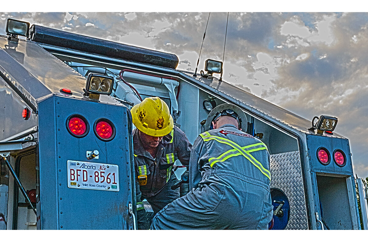 Bullet Wireline crew working on a unit under an evening sky