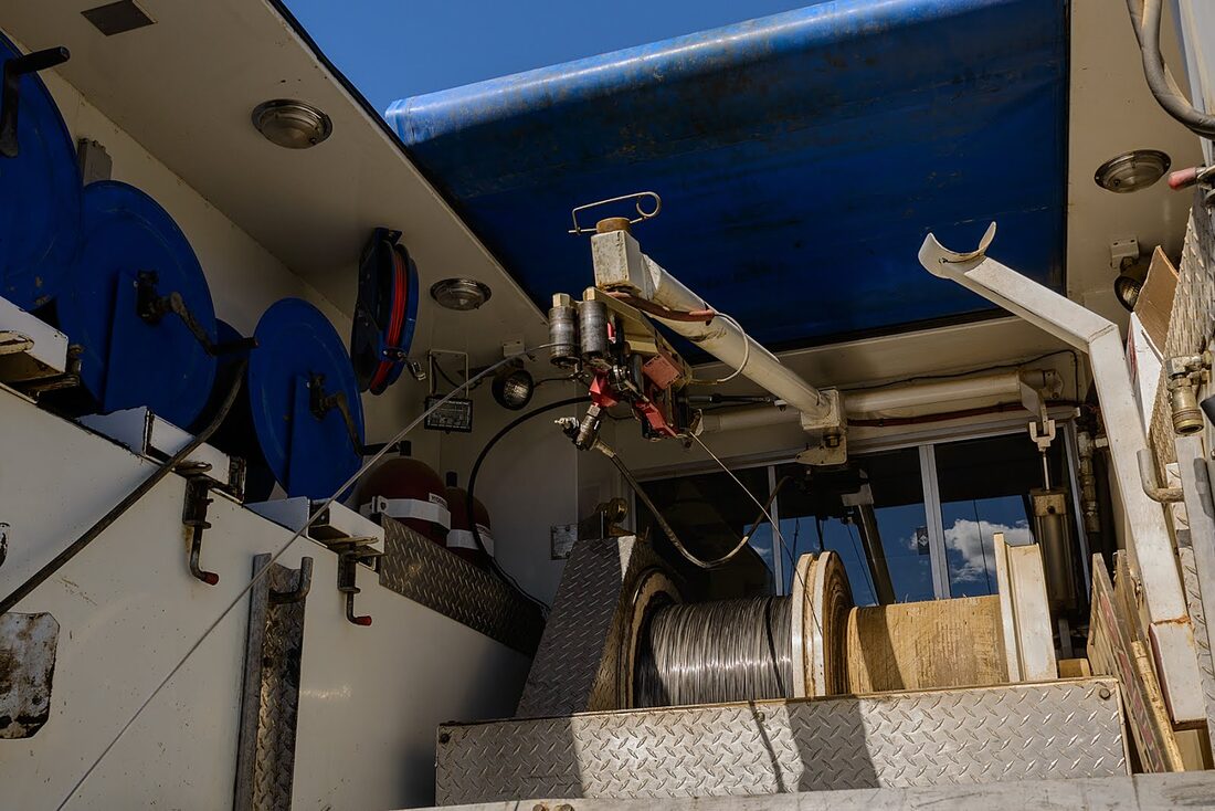 Slickline drum and tooling inside a Bullet Wireline unit